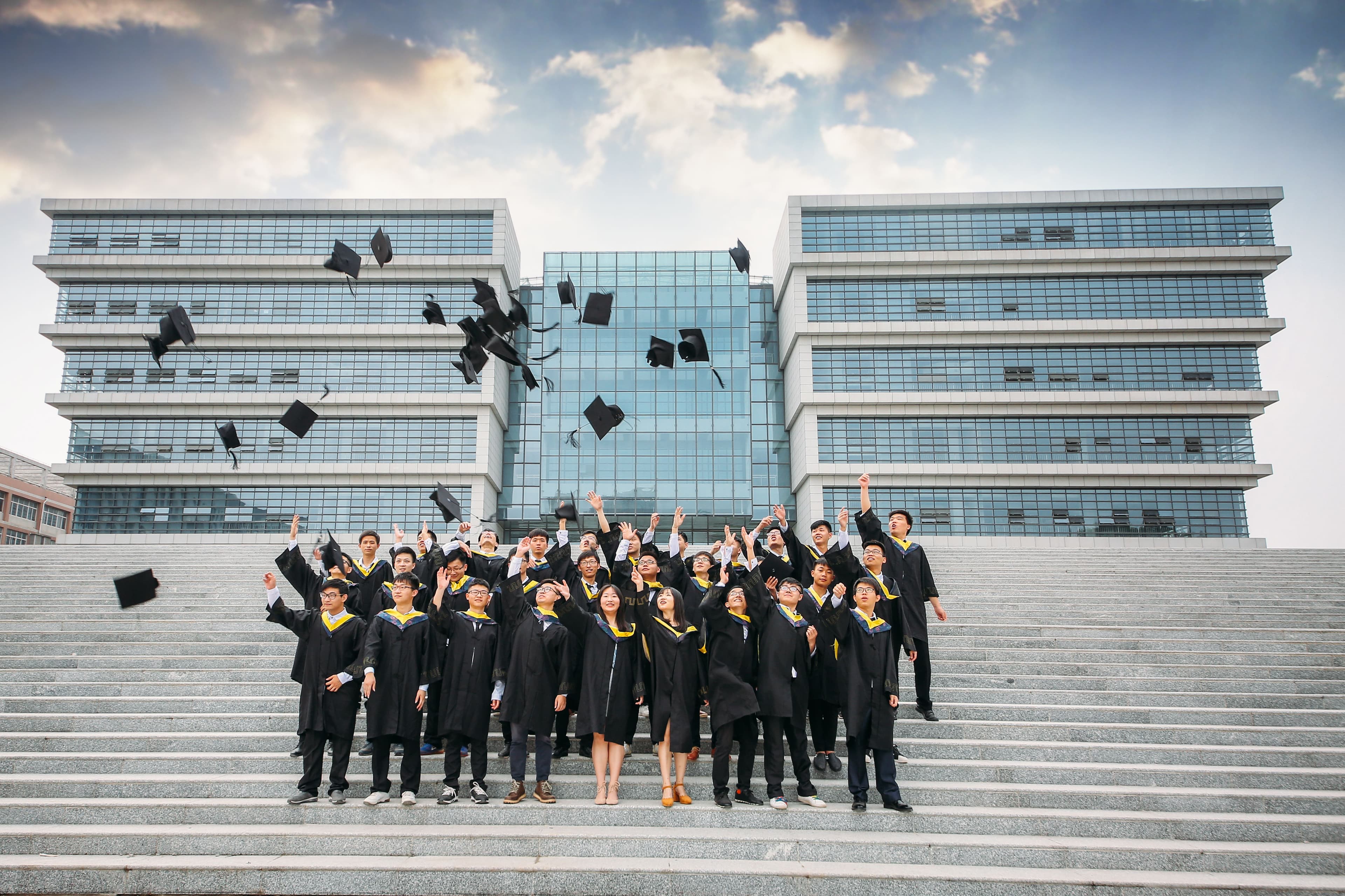 Graduates celebrating together outside their university